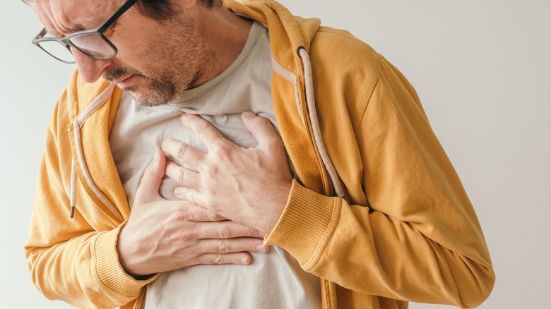 man holding chest