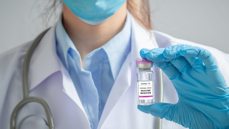 A doctor holds a COVID-19 booster