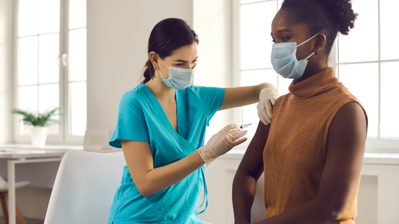 A woman gets a COVID-19 vaccine