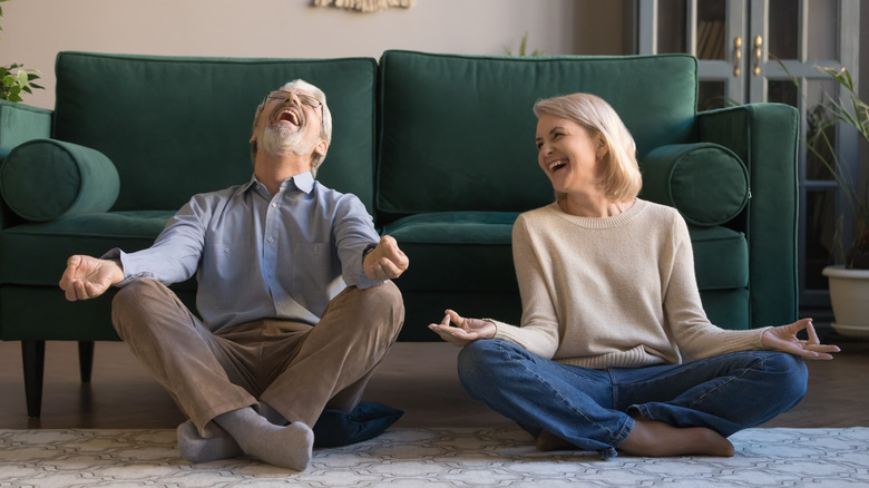 Woman and man doing laughter yoga