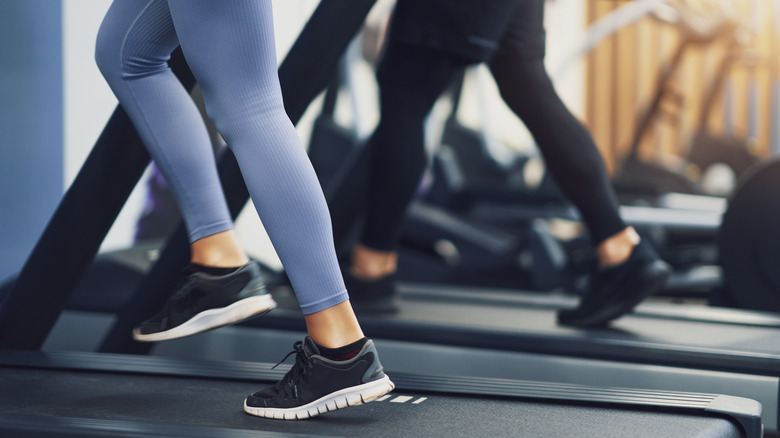 people working out their legs on treadmills