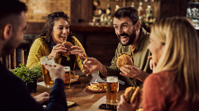 Group of friends eating hamburgers