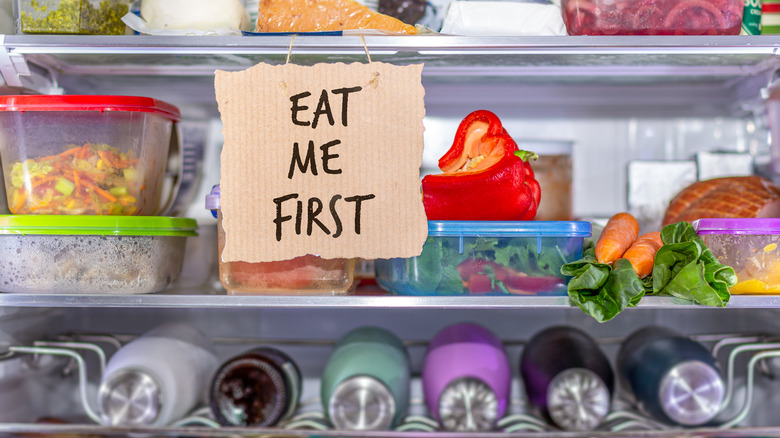 "eat me first" sign in front of leftovers