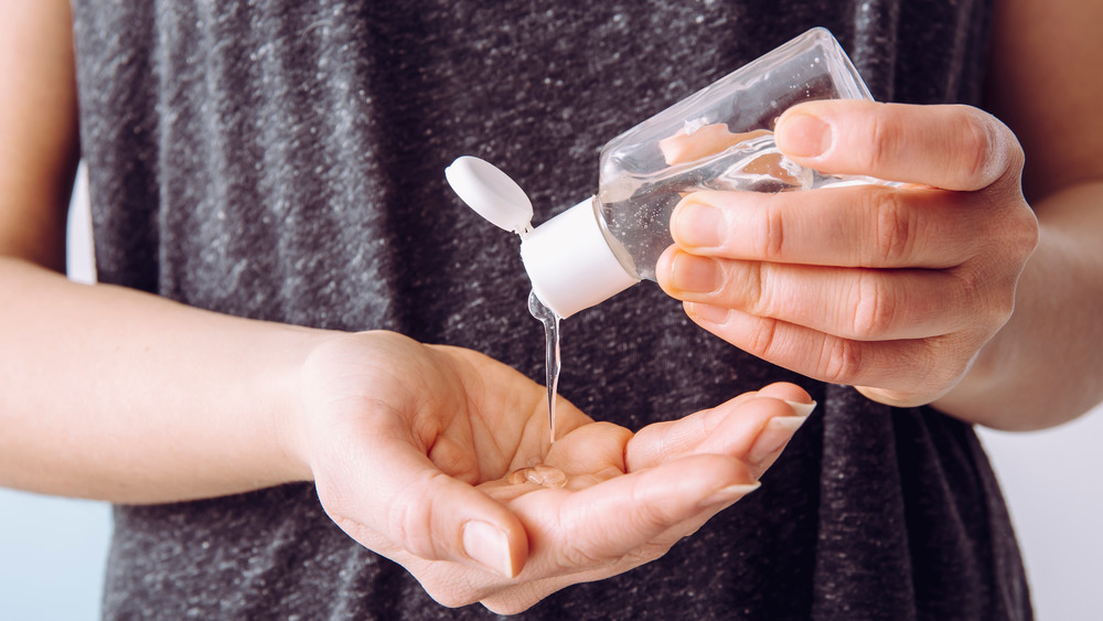 Woman squeezing hand sanitizer into her palm