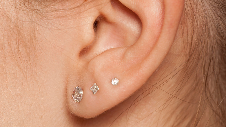 Woman's ear lobe piercing