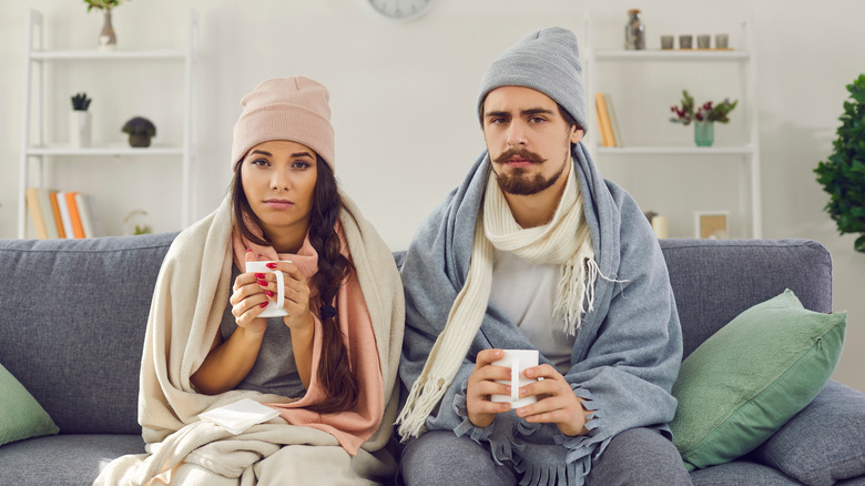 Couple with cold sitting together