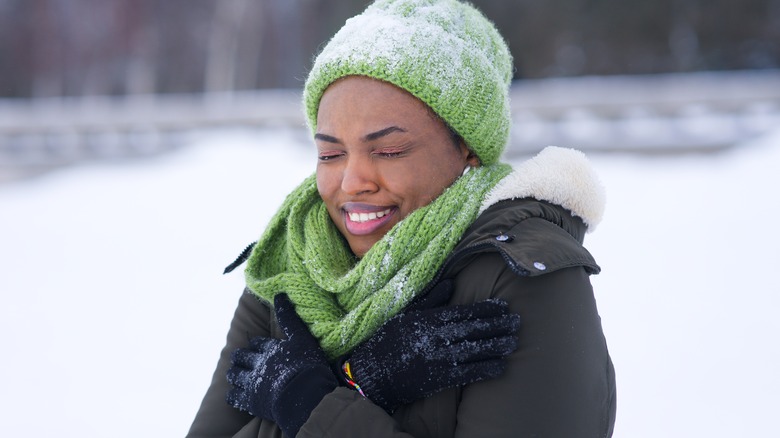 Cold woman shivering in snow