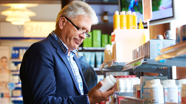 woman taking magnesium supplement with water