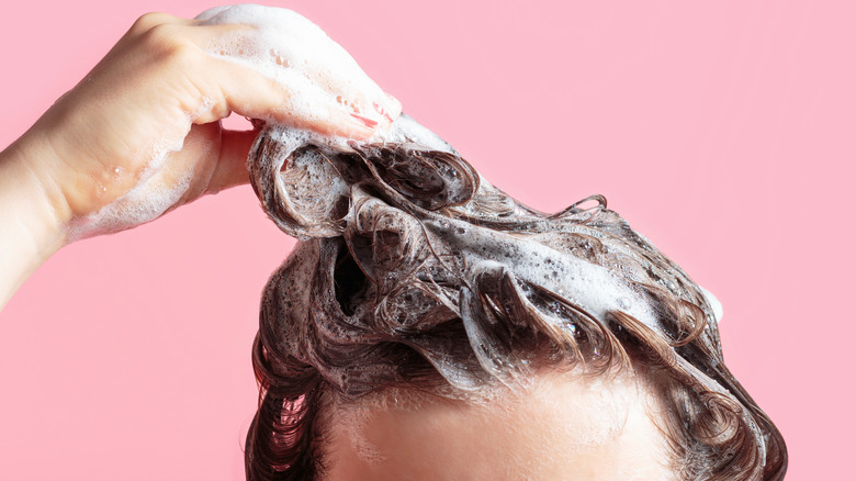 woman shampooing her head