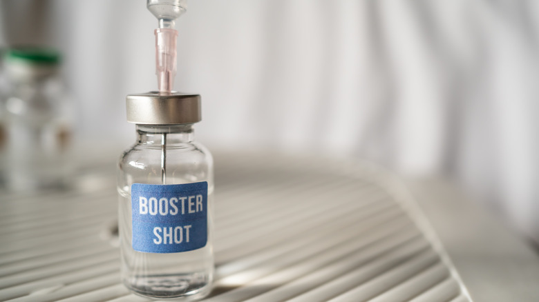 Covid-19 booster shot vaccine with needle in the vial