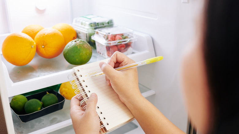 a women taking notes on her fruit