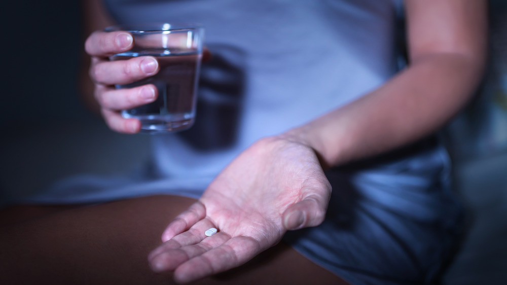 Hand holding a sleeping pill
