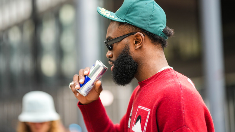 man about to drink red bull