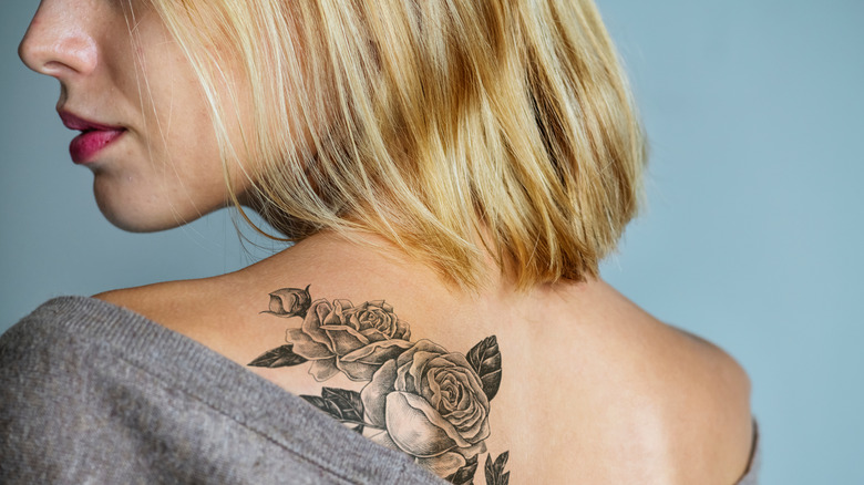 Woman with a rose tattoo on her back