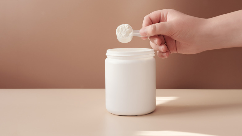 Holding a scoop of collagen