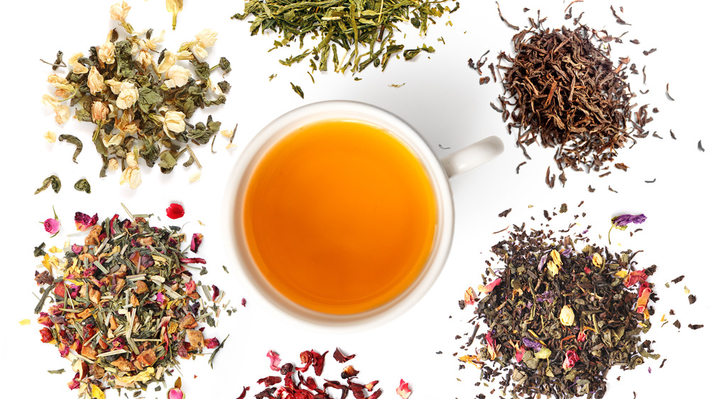 a cup of tea surrounded by dried tea leaves 