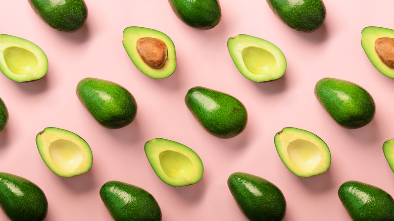 avocado flat lay on pink background