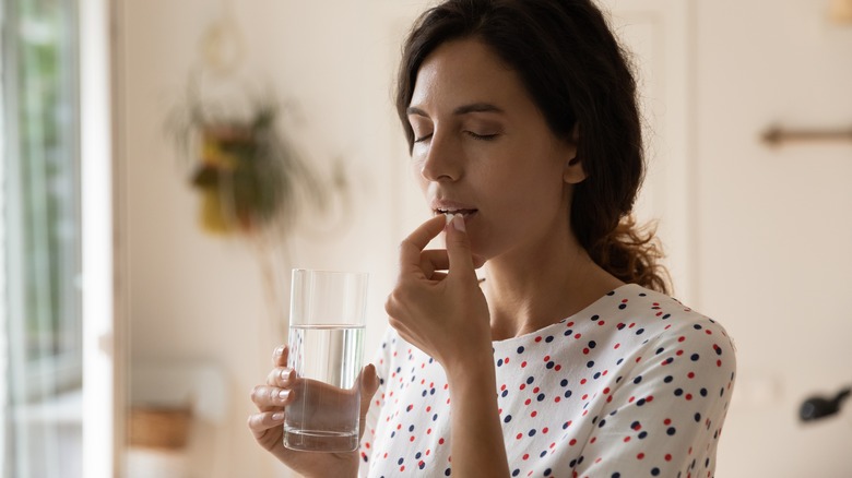 woman taking medications