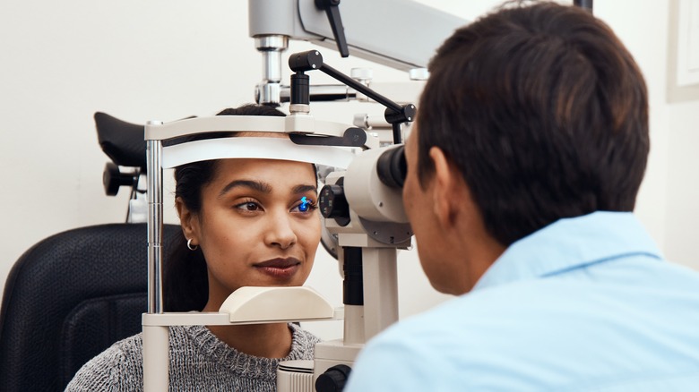 woman getting her eyes checked by a doctor