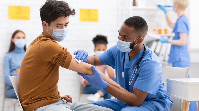 a doctor administering a Covid-19 vaccine