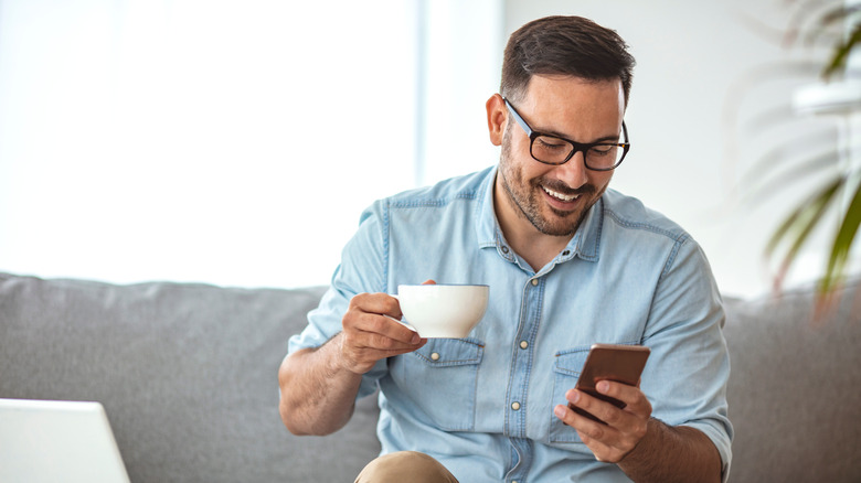 A man drinks a cup of coffee