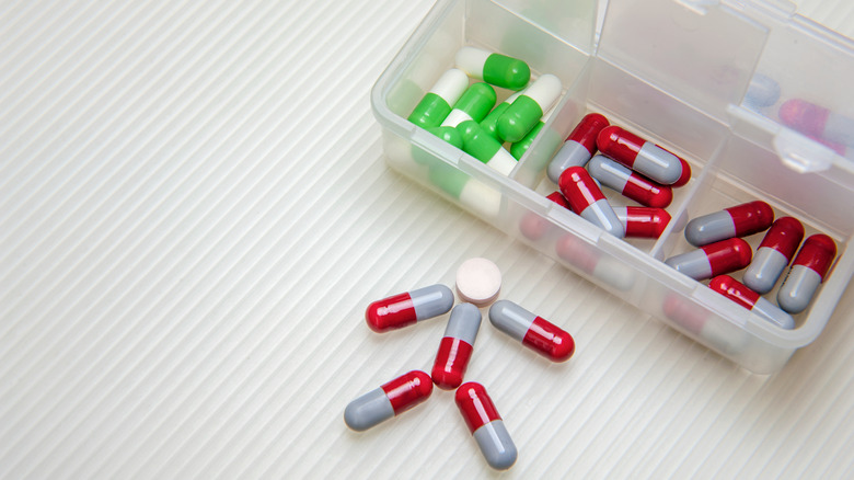 Pill organizer case with pills