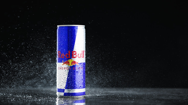 A can of Red Bull on a black background