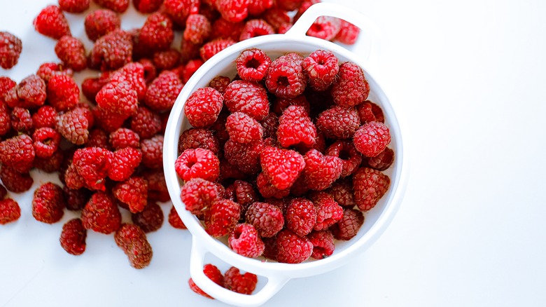 a bowl of red raspberries 