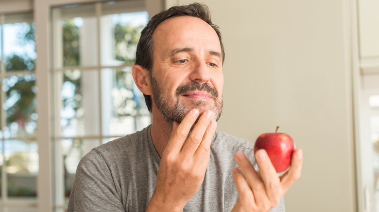 man holds apple