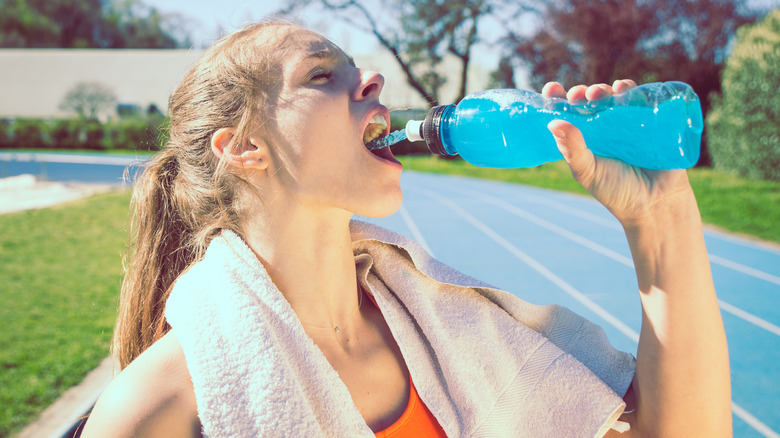 Woman drinking Gatorade from bottle