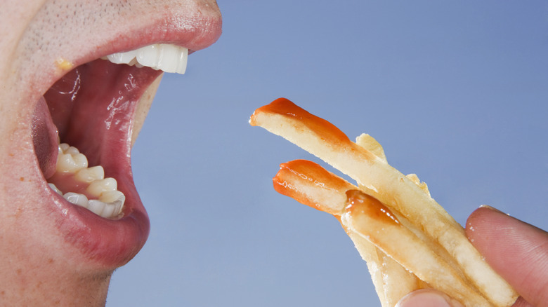 Person eating french fries