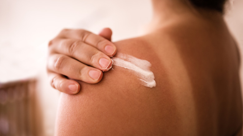Person applying sunscreen