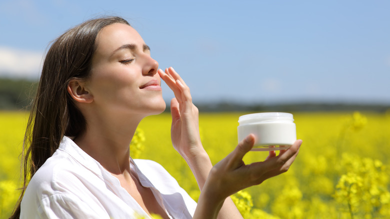 Woman applying sunscreen