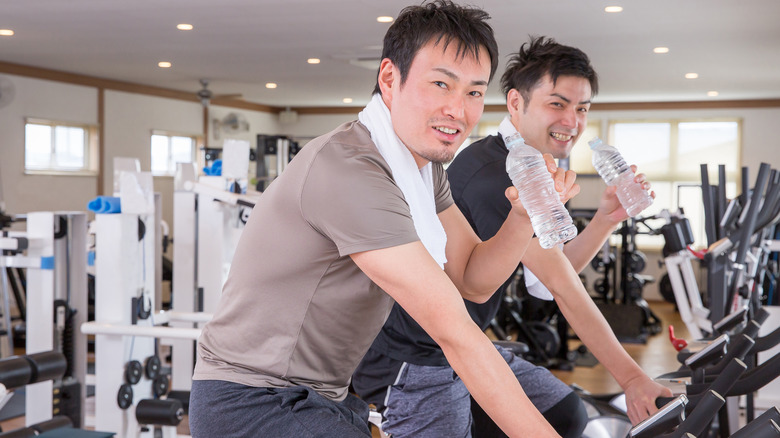 Men drinking water in gym