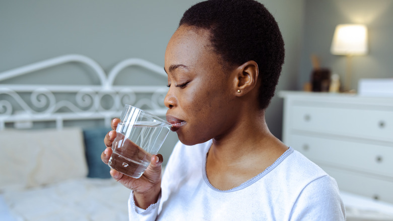 Young woman drinking glass of water