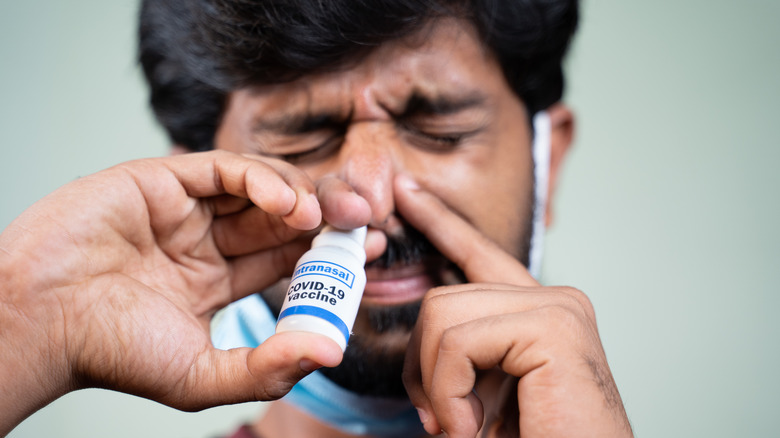 a man using nasal spray 