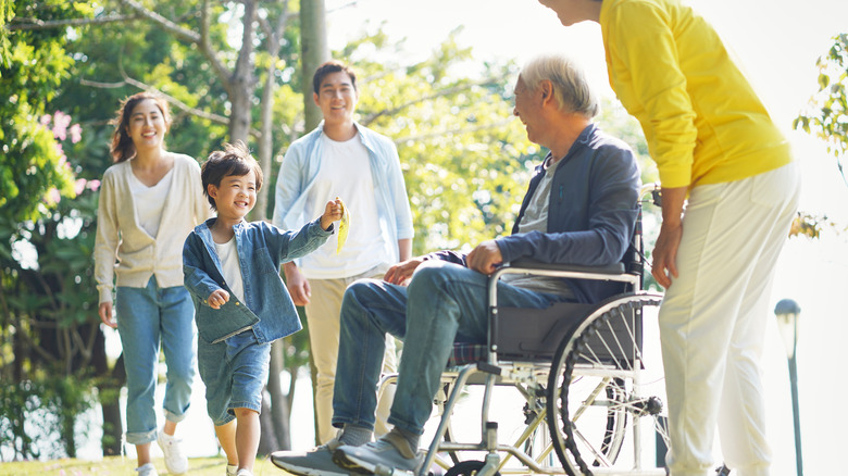 Family visiting patient in wheelchair