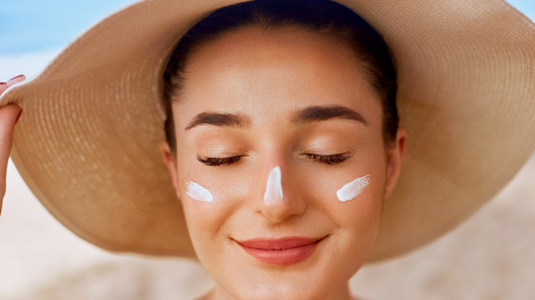 Woman with sunscreen at the beach