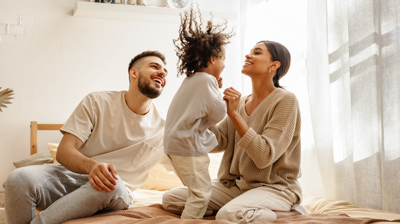 A mother, father, and child all in their pajamas