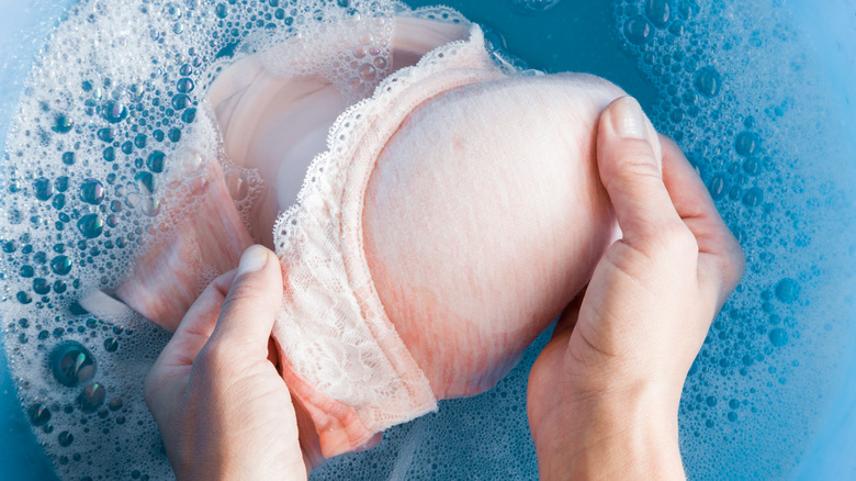 hands washing a bra