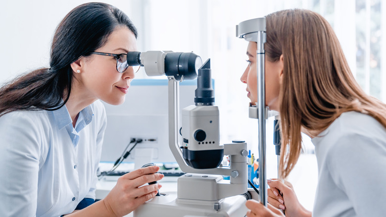 Woman optometrist examining woman patient