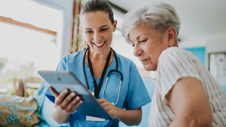 medical staff member showing female patient results