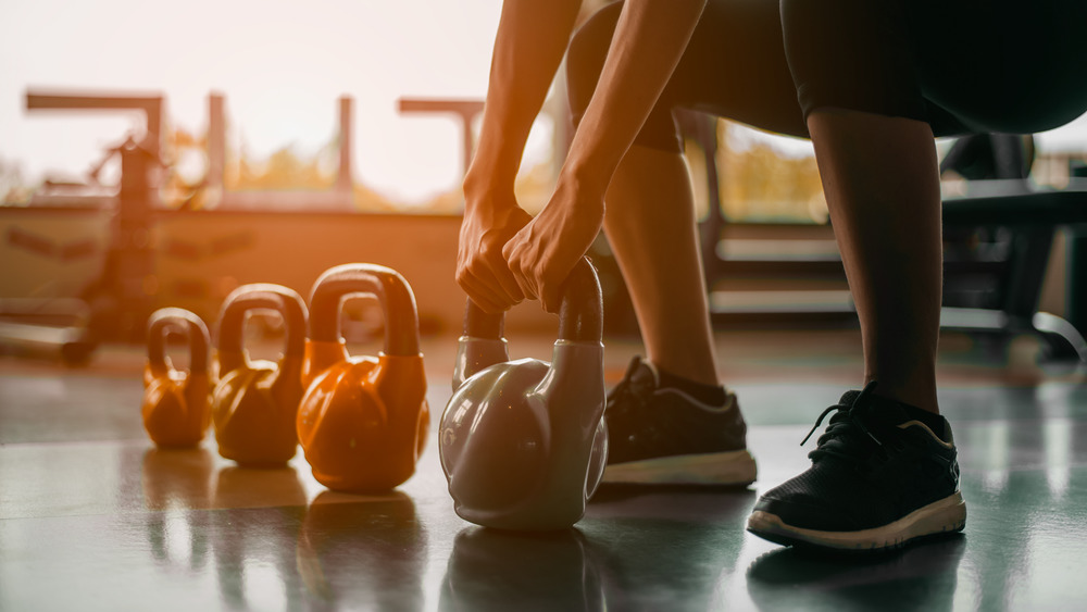 woman working out with kettlebells