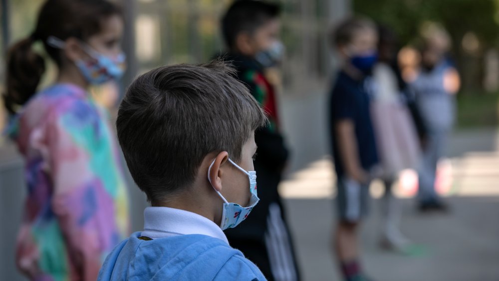 Masked children line up for school pictures