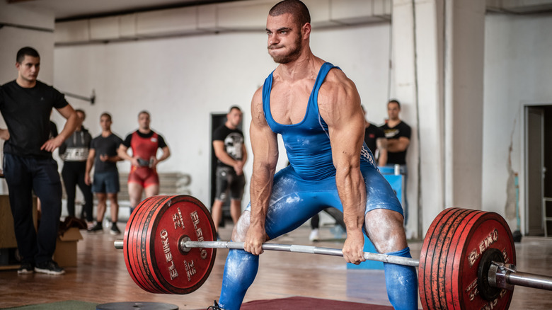 a man lifting a heavy barbell