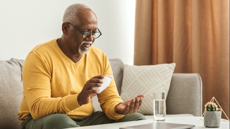 man taking tablets