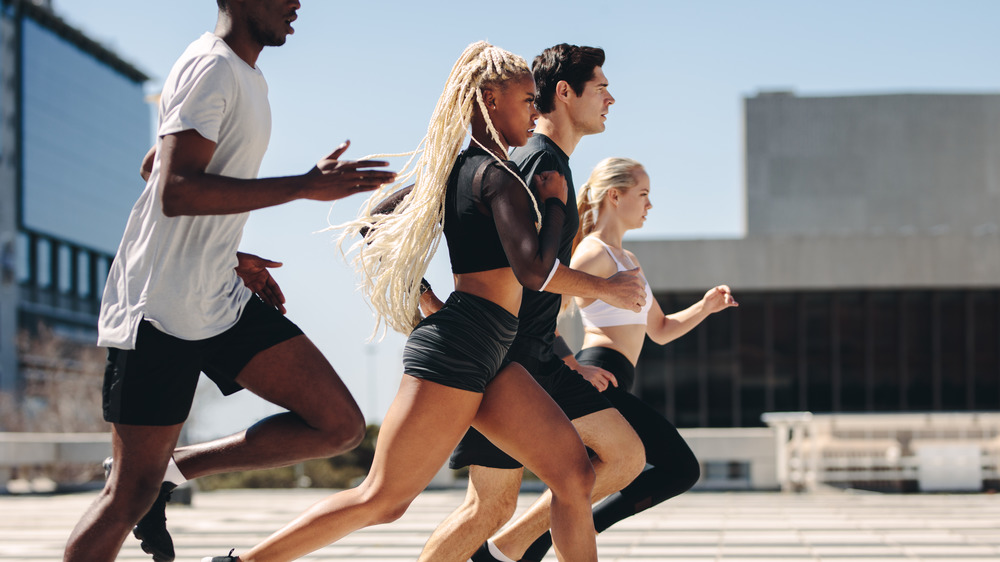 A group of athletic youth going for a run in the city 