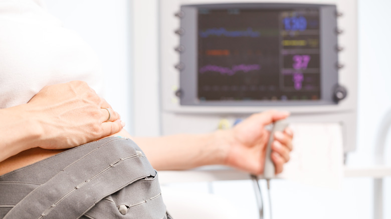 Pregnant woman at the doctor monitoring baby's heartbeat
