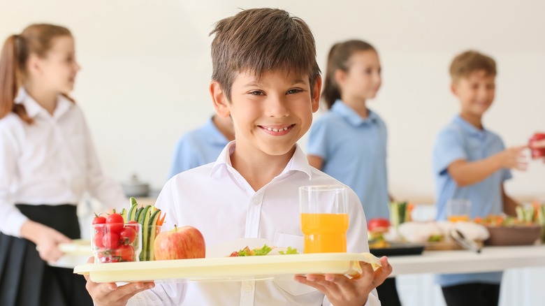 boy with a tray of healthy lunch food