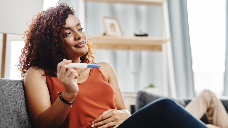 Woman holding pregnancy test